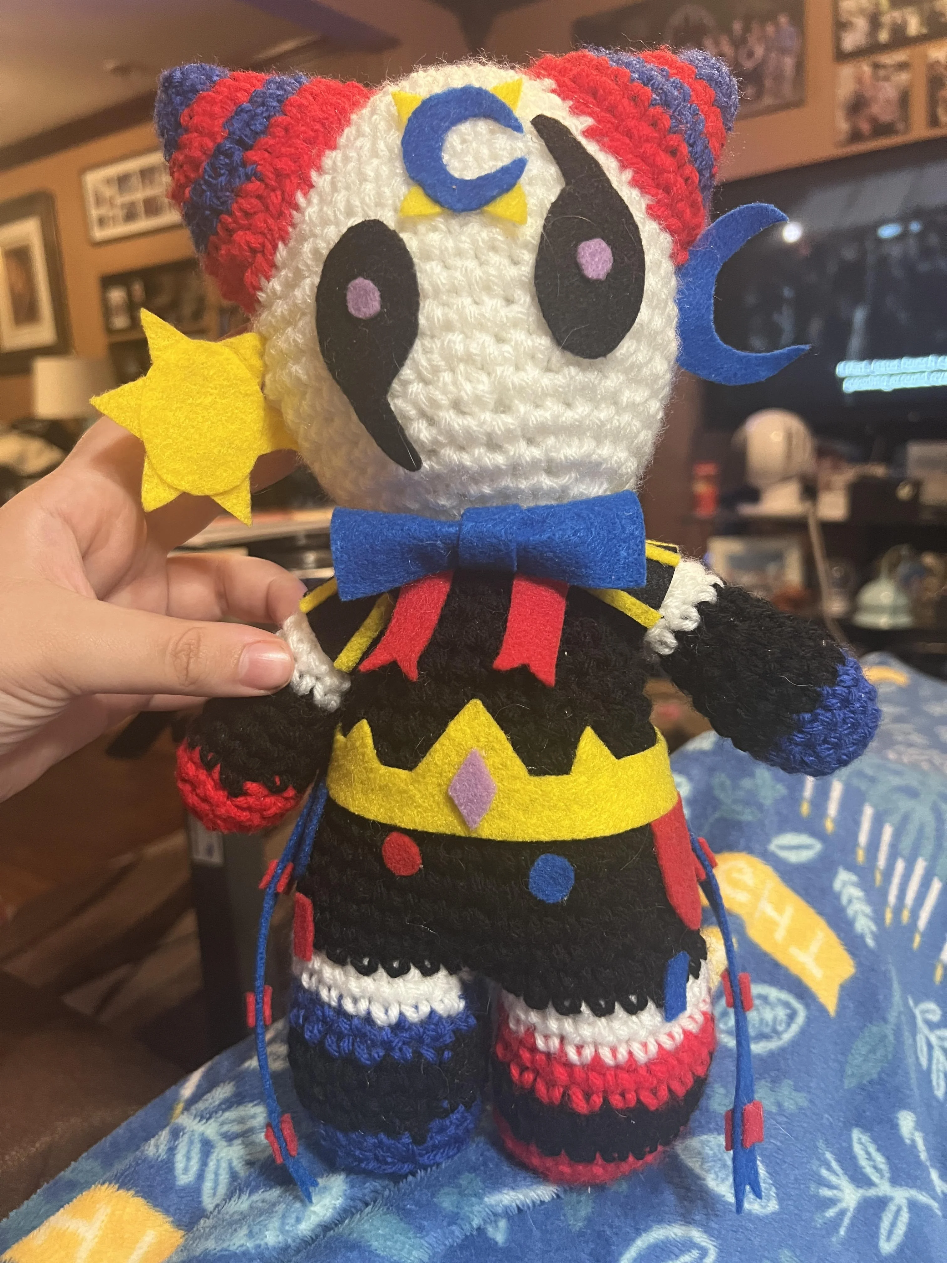 Colorful clown-like crochet doll